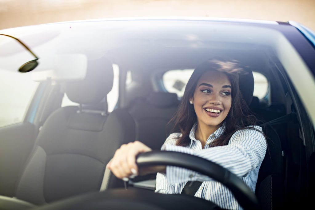 road rage affects drivers - Happy calm woman driving a car and smiling.