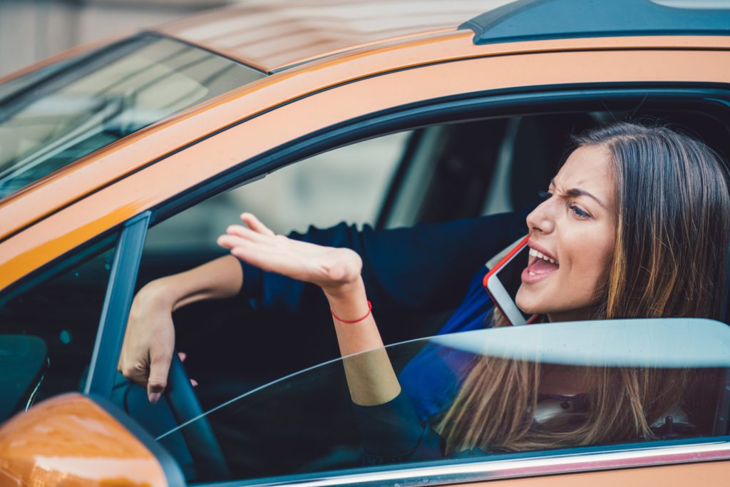 road rage affects drivers - Young woman stressed and angered about the traffic